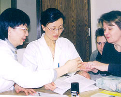 Dr. May Wang discussing herbal remedies with a patient